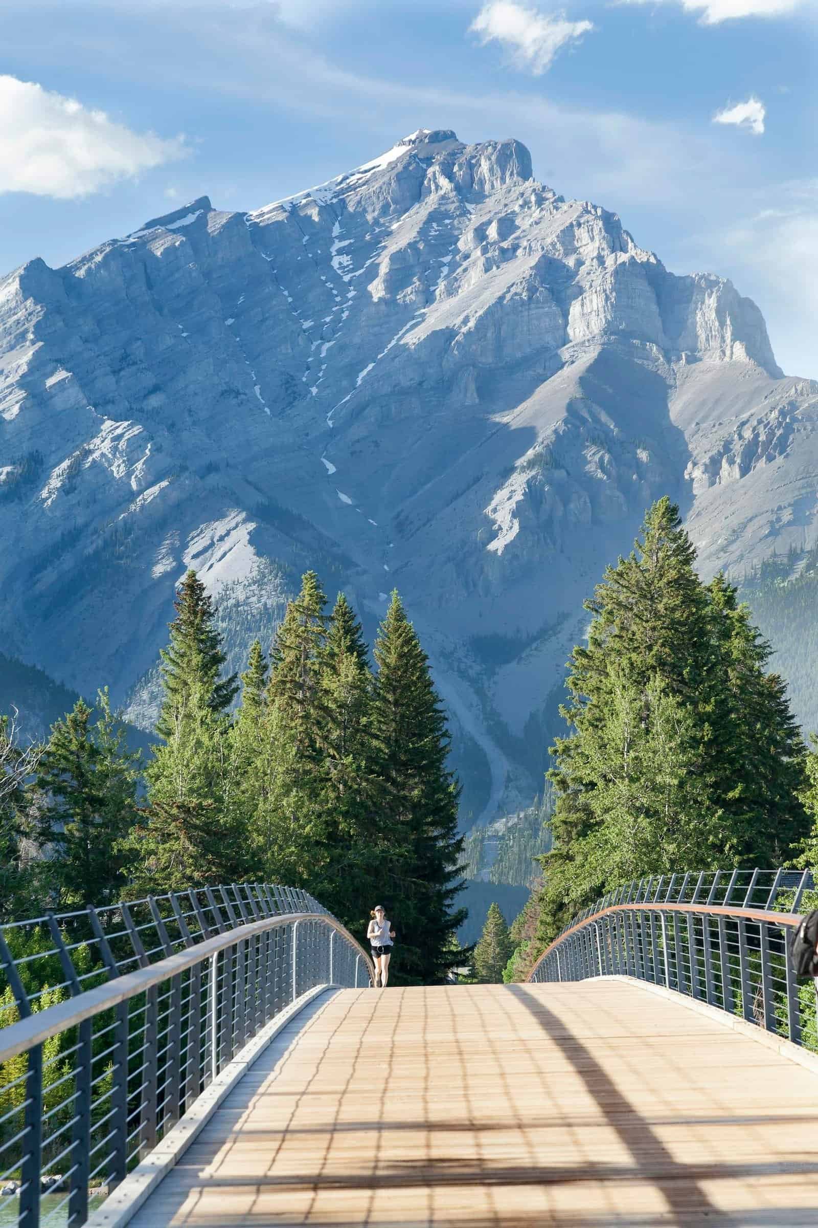 A picturesque scene showcasing a bridge with a backdrop of majestic mountains in Banff National Park.
