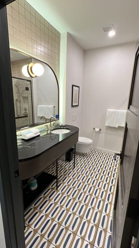 The author showing an image of the bathroom area when she stayed at The Westley Hotel Calgary