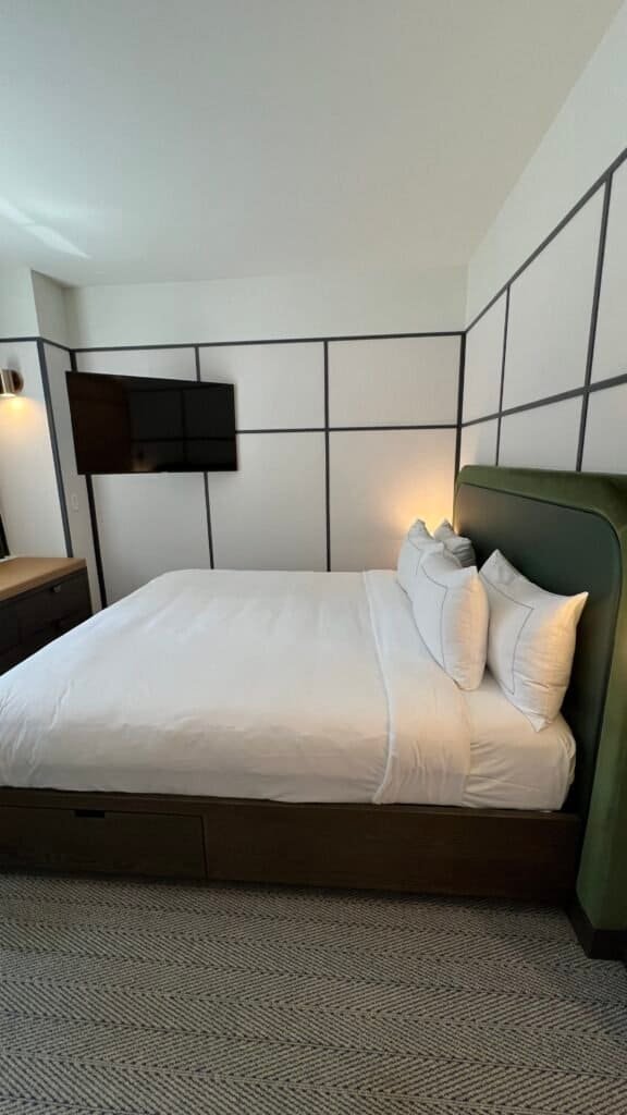 The author showing an image of the sleeping area when she stayed at The Westley Hotel Calgary