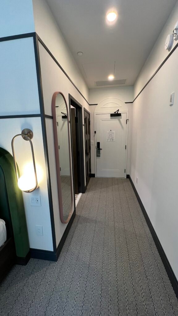 The author showing an image of the entryway when she stayed at The Westley Hotel Calgary